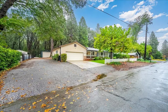 a view of backyard of house with green space