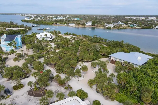 an aerial view of lake and residential houses with outdoor space