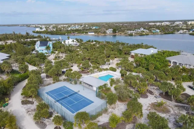 an aerial view of residential houses with outdoor space and river