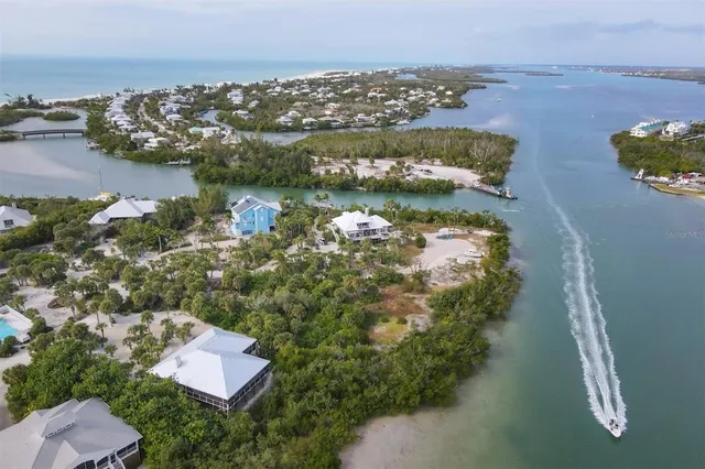an aerial view of residential house with outdoor space and lake view