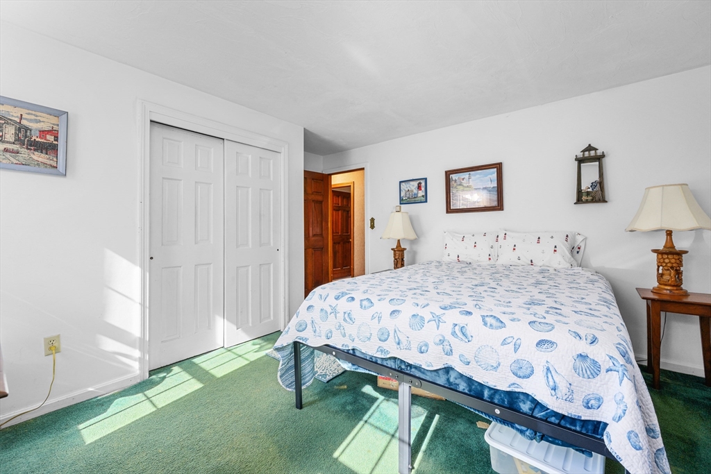 125 Wamsutta Road Eastham, MA 02642 - Photo 26 of 42 a bedroom with a bed a rug and a closet