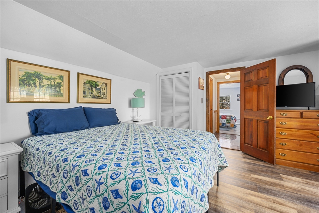 125 Wamsutta Road Eastham, MA 02642 - Photo 33 of 42 a bedroom with a large bed and a dresser