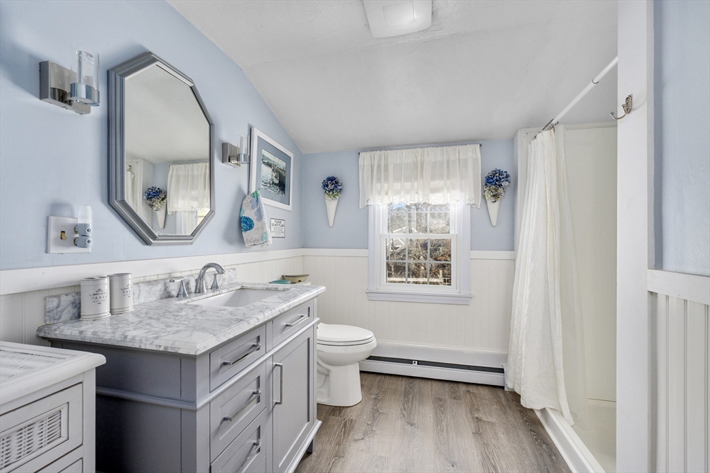 125 Wamsutta Road Eastham, MA 02642 - Photo 34 of 42 a bathroom with a granite countertop toilet sink and mirror