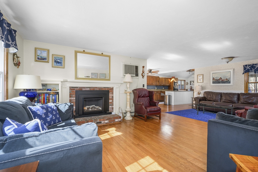125 Wamsutta Road Eastham, MA 02642 - Photo 5 of 42 a living room with furniture and a fireplace