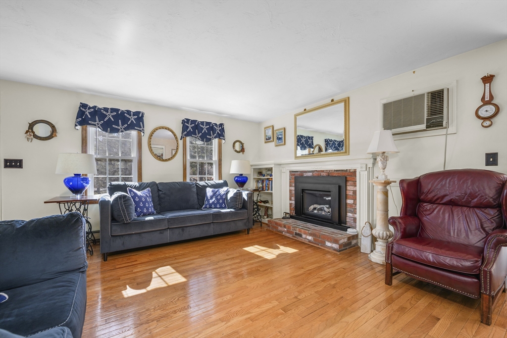 125 Wamsutta Road Eastham, MA 02642 - Photo 7 of 42 a living room with furniture and a fireplace