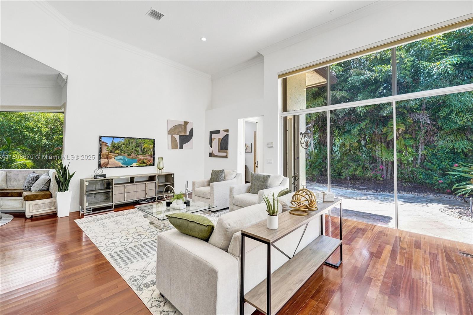 169 Dockside Circle Weston, FL 33327 - Photo 11 of 61 a living room with furniture large window and wooden floor