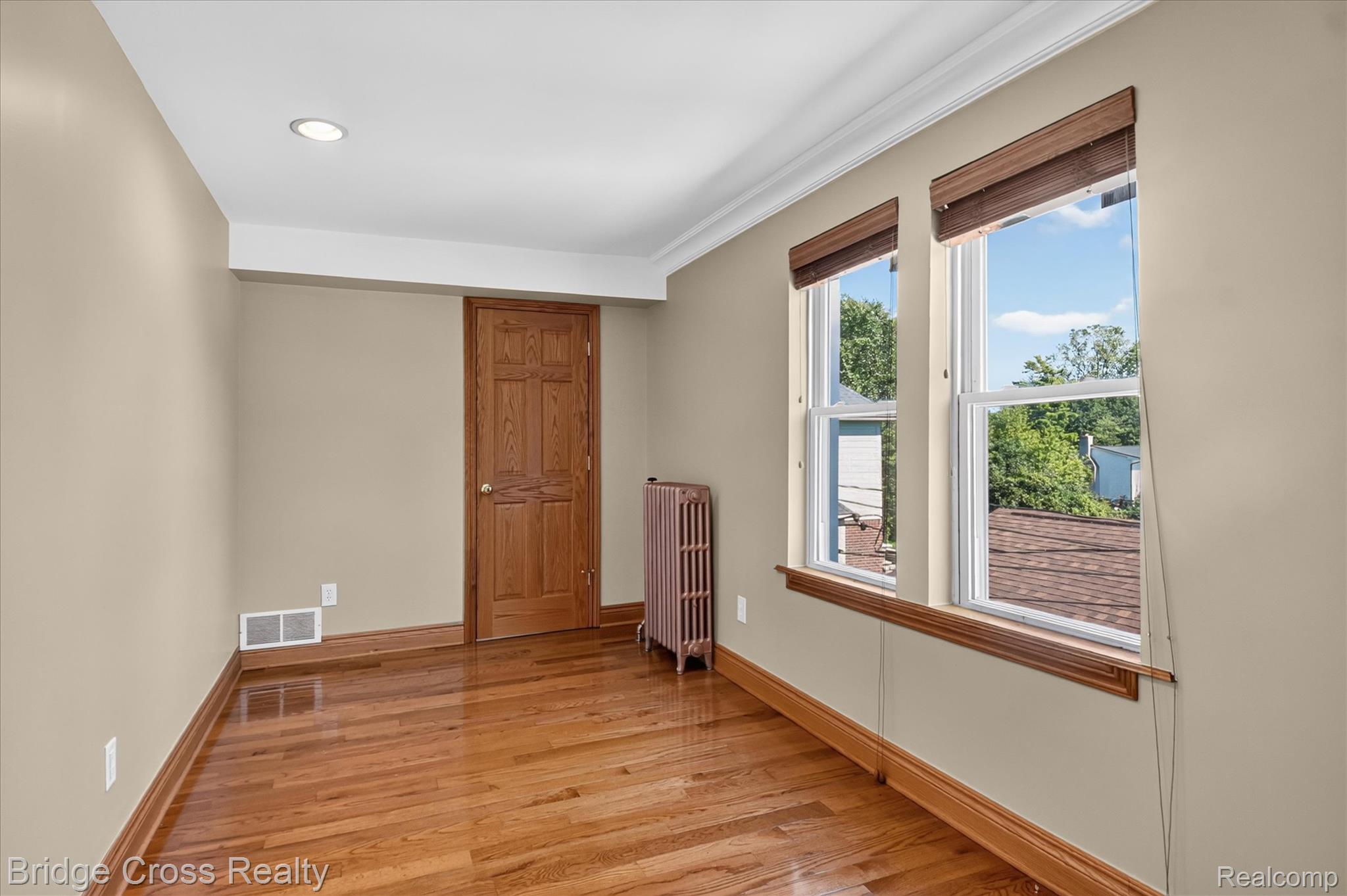 285 East Long Lake Road Troy, MI 48085 - Photo 26 of 49 Bright corner room featuring gleaming wood-finish flooring, crown molding, and recessed ceiling lighting