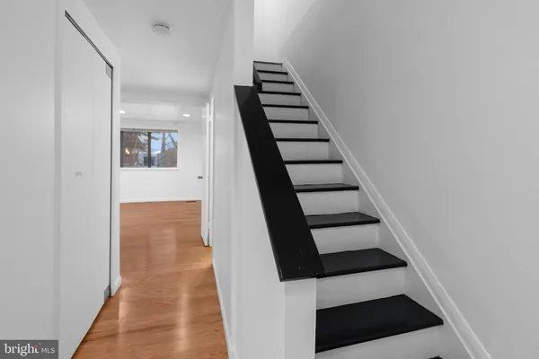 a view of entryway and hall with wooden floor