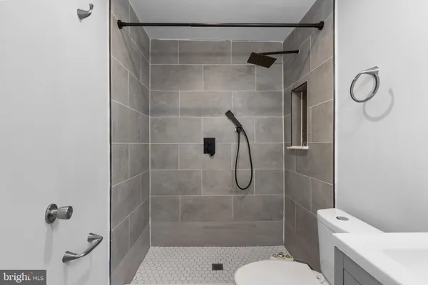 a bathroom with a shower toilet and sink