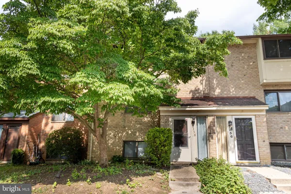 a front view of house with a garden