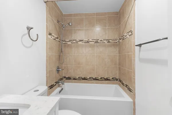 a bathroom with a bath tub with a shower