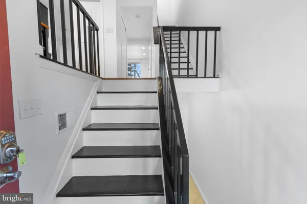 a view of staircase with white walls and a window