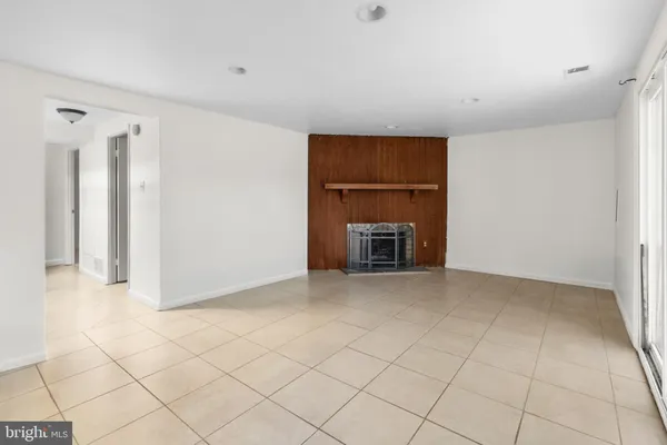a view of empty room with a fireplace
