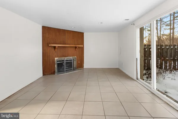 an empty room with furniture and a window