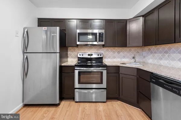 a kitchen with a refrigerator and a stove
