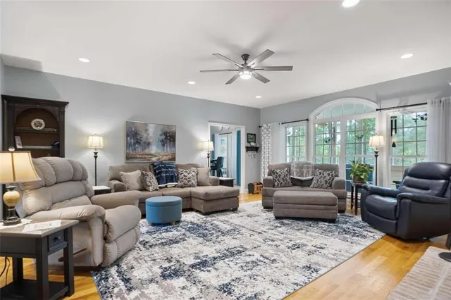 a living room with furniture ceiling fan and a rug