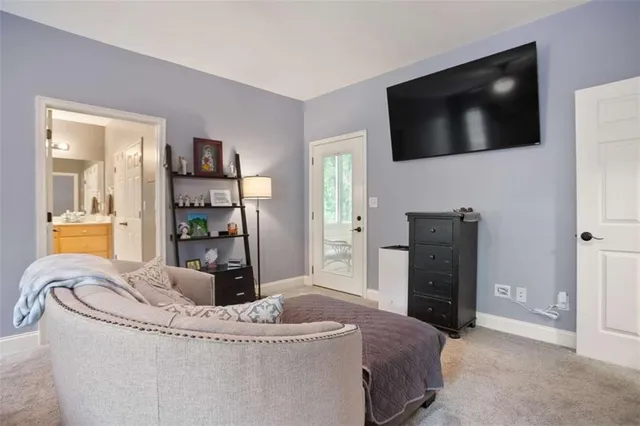 a living room with a flat screen tv and a refrigerator