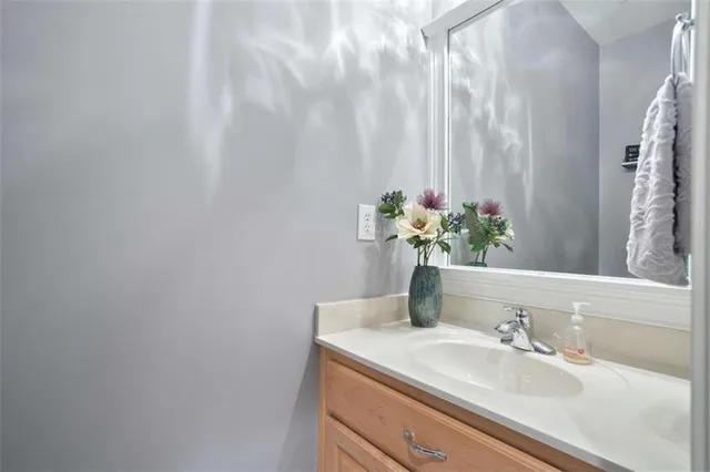 a bathroom with a sink a vanity and a mirror