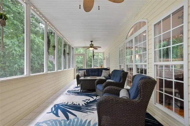a living room with furniture tv and a large window