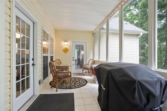 a living room with furniture and a floor to ceiling window