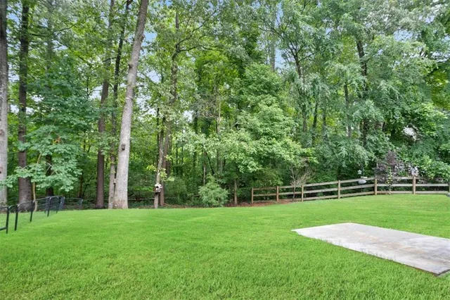 a view of a field with grass and a trees