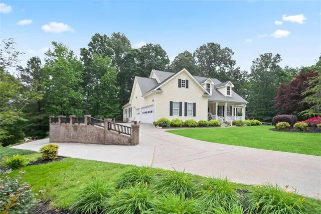 an aerial view of a house with a yard and trees
