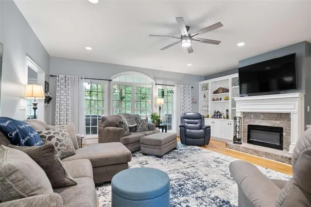 a living room with furniture a flat screen tv and a fireplace
