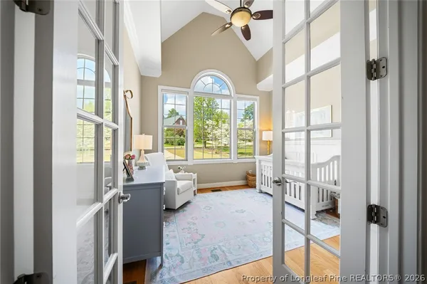 a bedroom with furniture and a large window