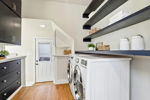 a utility room with cabinets washer and dryer
