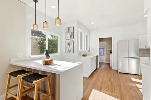 a kitchen with sink cabinets and refrigerator