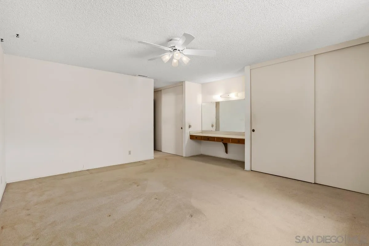 1740 Kirk Place Carlsbad, CA 92008 - Photo 12 of 22 an empty room with a ceiling fan and a window