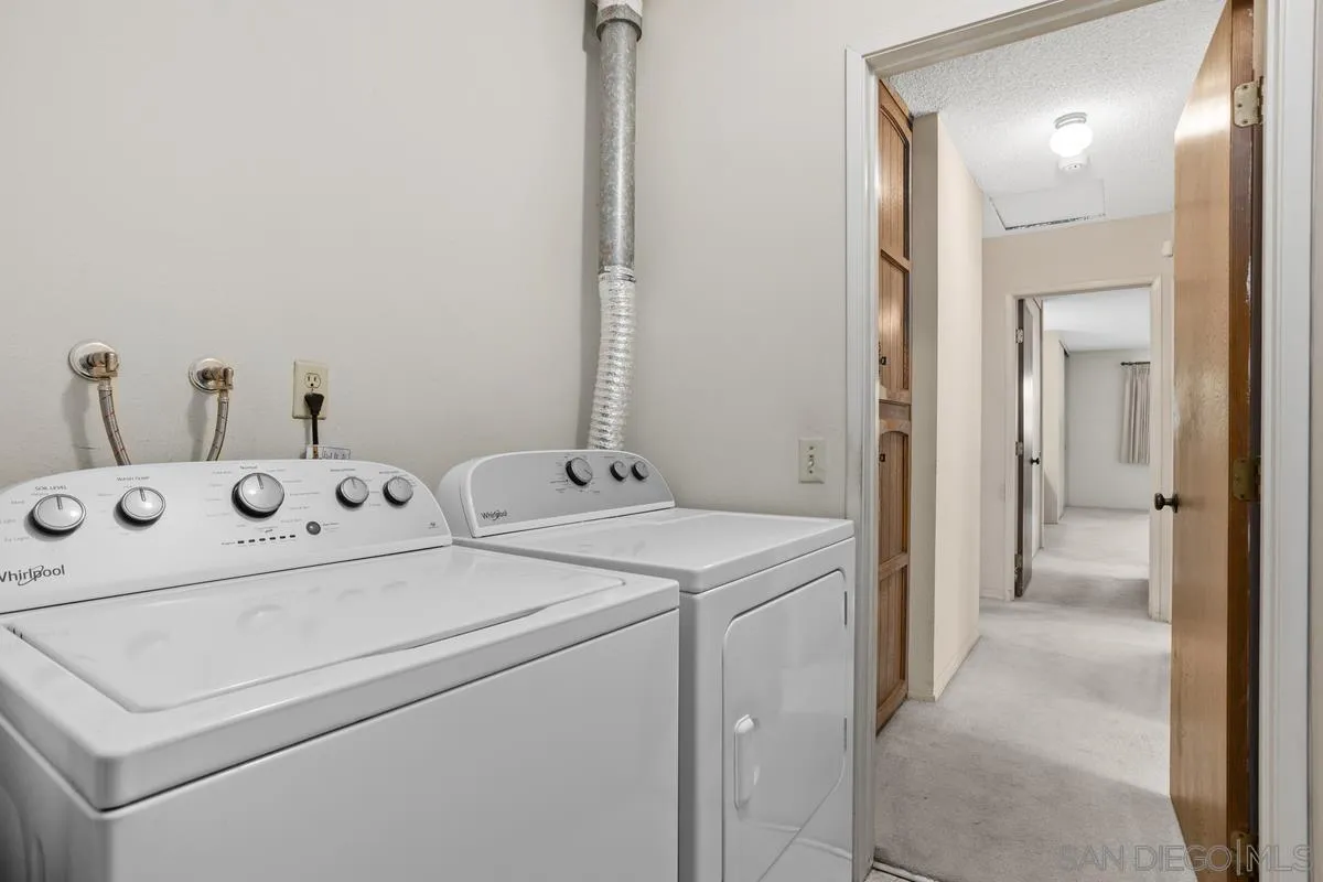 1740 Kirk Place Carlsbad, CA 92008 - Photo 18 of 22 a view of washer and dryer with bathroom in the background
