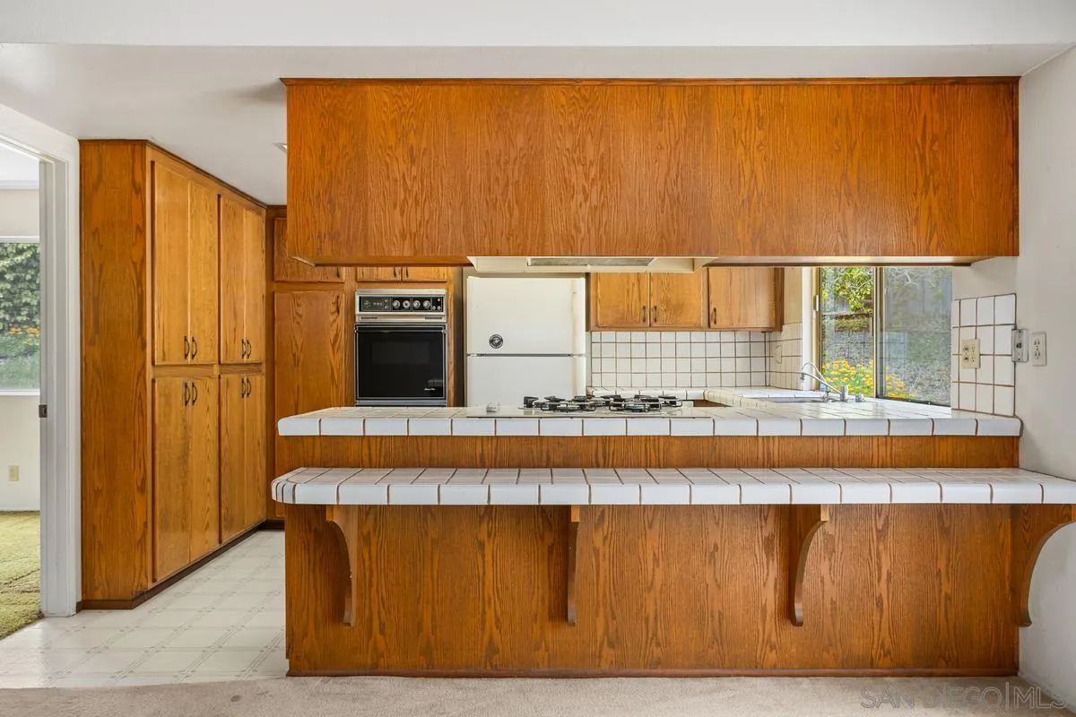 1740 Kirk Place Carlsbad, CA 92008 - Photo 6 of 22 a living room with a table and chair
