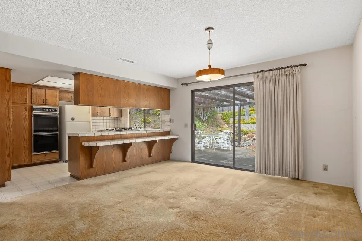 1740 Kirk Place Carlsbad, CA 92008 - Photo 7 of 22 a view of kitchen with stainless steel appliances granite countertop cabinets and outdoor space