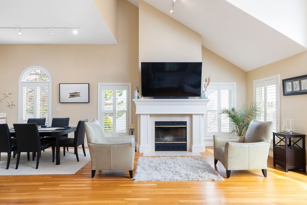 7 Cutter Lane, Unit 7 Quincy, MA 02171 - Photo 1 of 28 a living room with furniture a fireplace and a flat screen tv