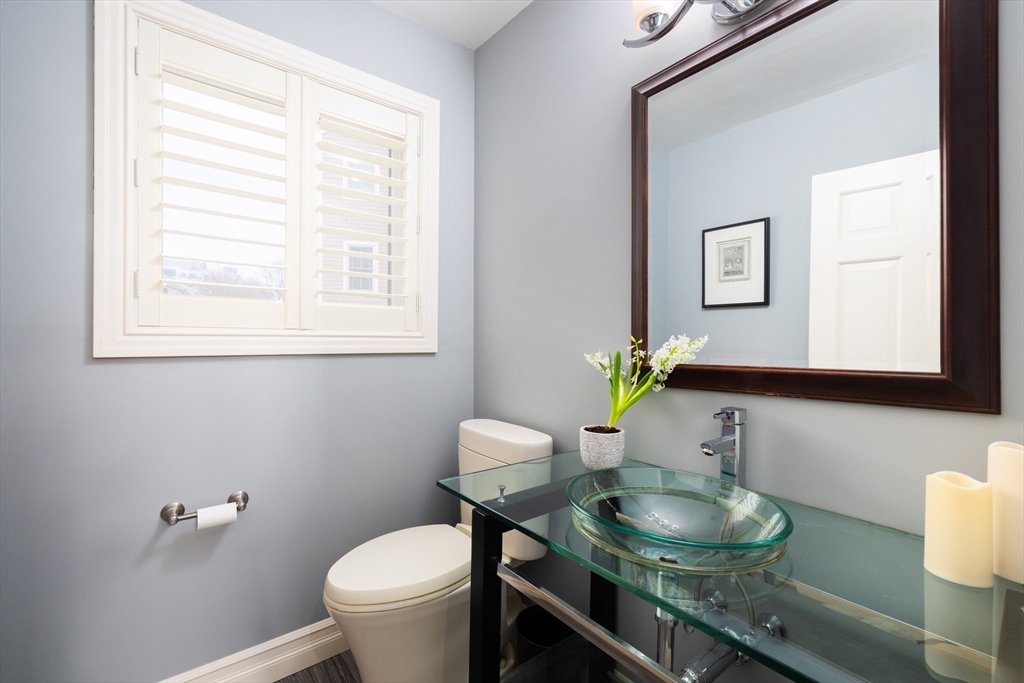 7 Cutter Lane, Unit 7 Quincy, MA 02171 - Photo 11 of 28 a bathroom with a toilet a sink and a mirror