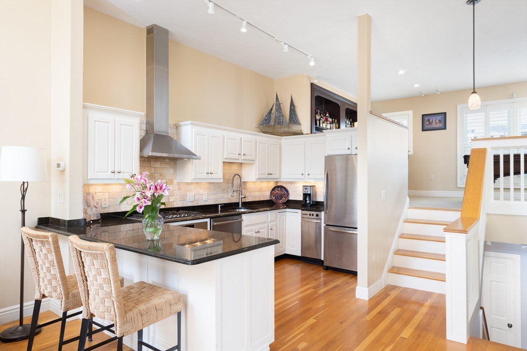 7 Cutter Lane, Unit 7 Quincy, MA 02171 - Photo 3 of 28 a kitchen with stainless steel appliances granite countertop a refrigerator and a stove top oven