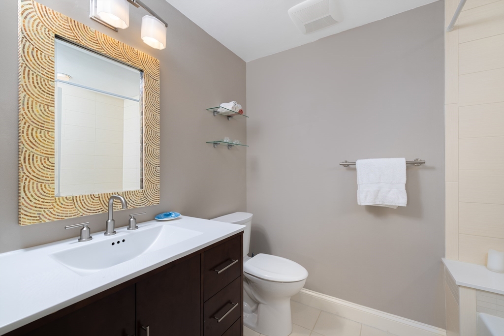 7 Cutter Lane, Unit 7 Quincy, MA 02171 - Photo 8 of 28 a bathroom with a sink vanity mirror and toilet