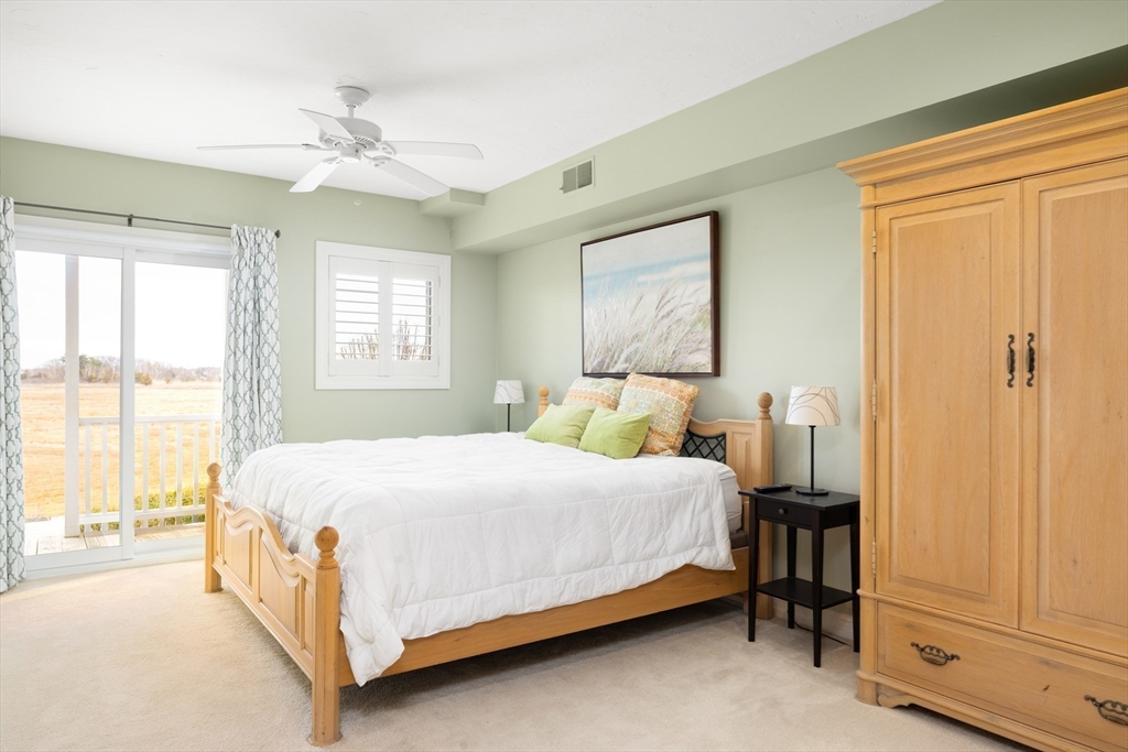 7 Cutter Lane, Unit 7 Quincy, MA 02171 - Photo 9 of 28 a bedroom with a bed table and a window