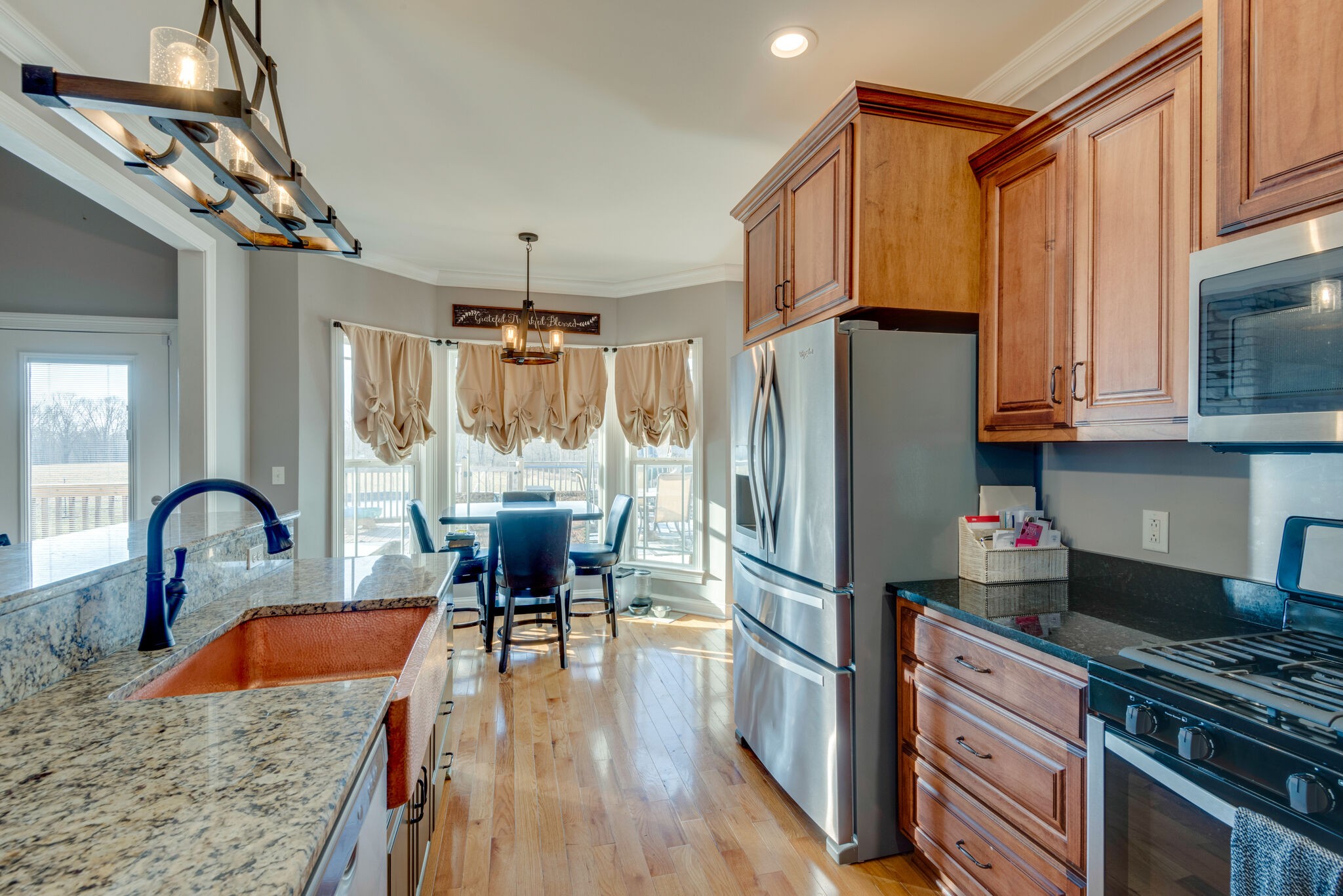 2822 Lock Hollow Road Dickson, TN 37055 - Photo 17 of 45 a kitchen with granite countertop a refrigerator and wooden cabinets
