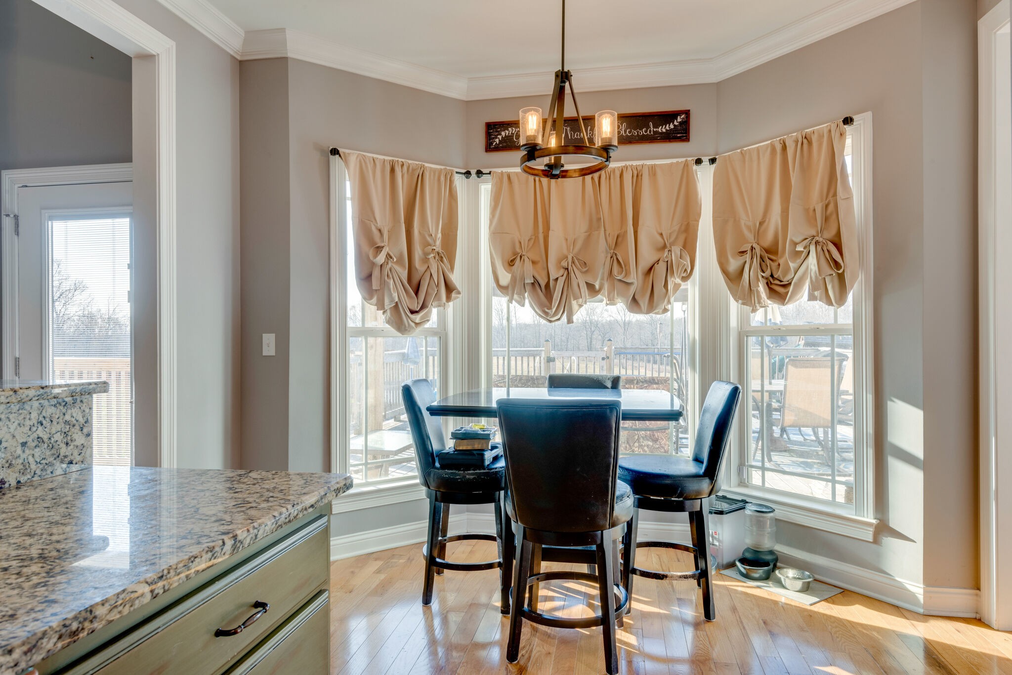 2822 Lock Hollow Road Dickson, TN 37055 - Photo 18 of 45 a dining room with wooden floor a chandelier a wooden table and chairs