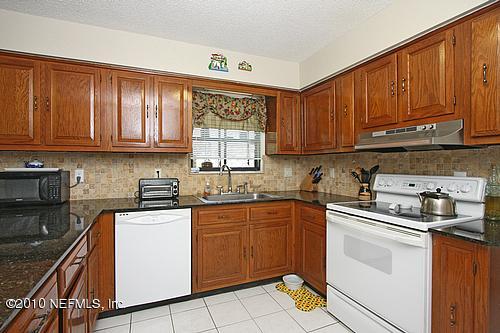 1295 Marlee Road St. Johns, FL 32259 - Photo 4 of 16 a kitchen with stainless steel appliances granite countertop a sink stove and cabinets