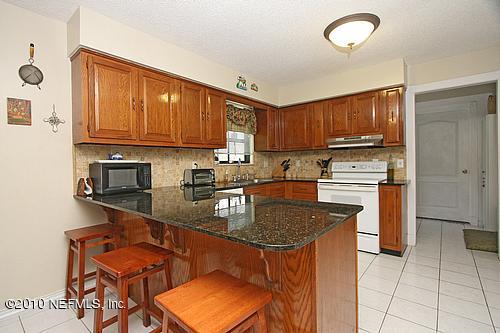 1295 Marlee Road St. Johns, FL 32259 - Photo 5 of 16 a kitchen with stainless steel appliances granite countertop a stove a sink and a refrigerator
