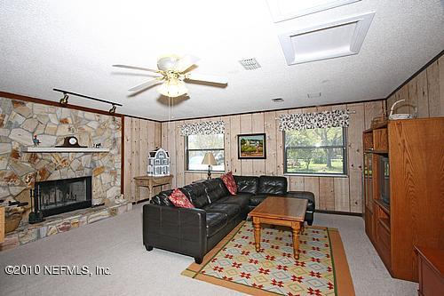 1295 Marlee Road St. Johns, FL 32259 - Photo 7 of 16 a living room with furniture and a fireplace