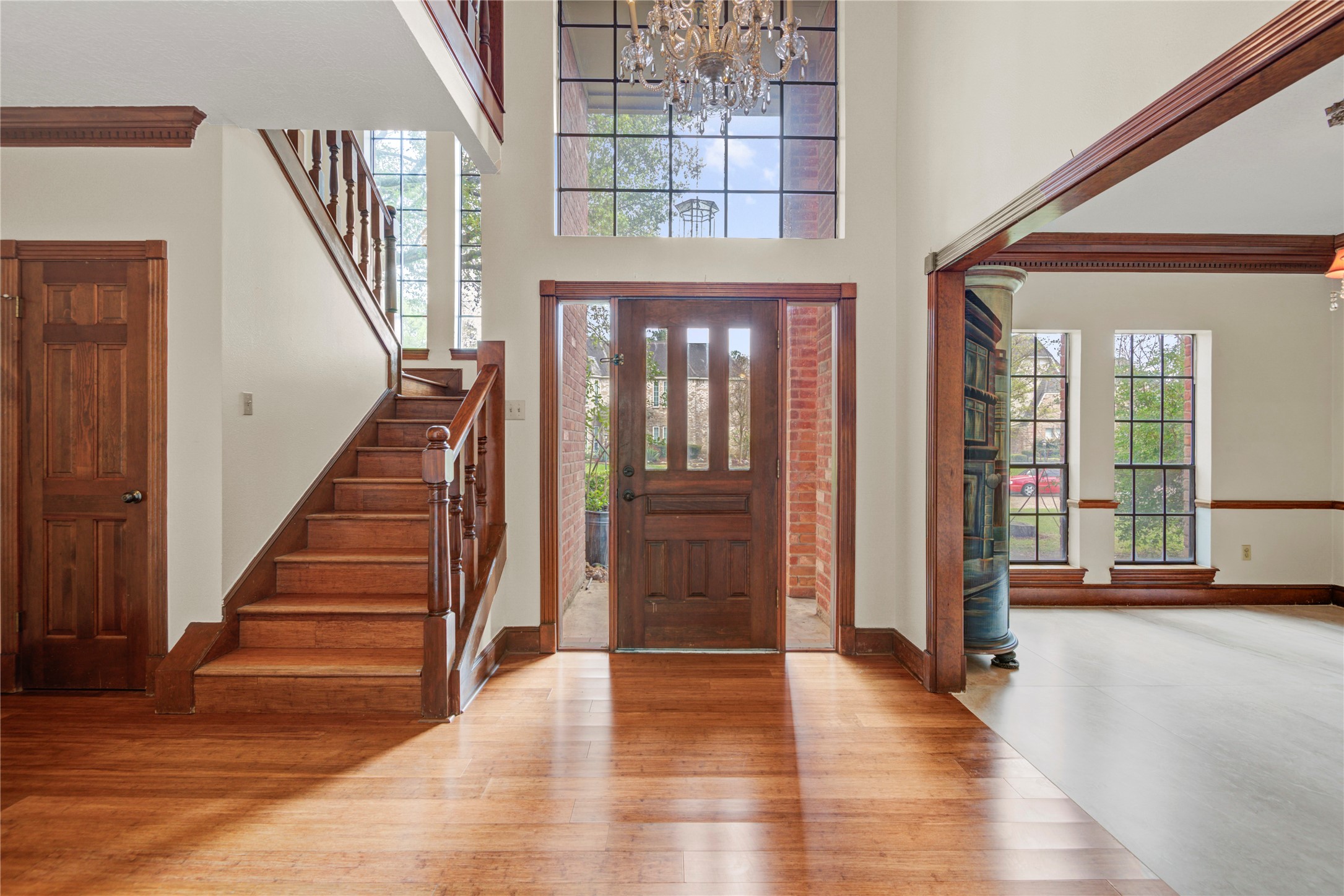 8412 Hidden Trail Lane Spring, TX 77379 - Photo 5 of 43 The welcoming foyer features bamboo flooring, a staircase with classic railing, and convenient access to a massive coat closet tucked beneath the stairs.