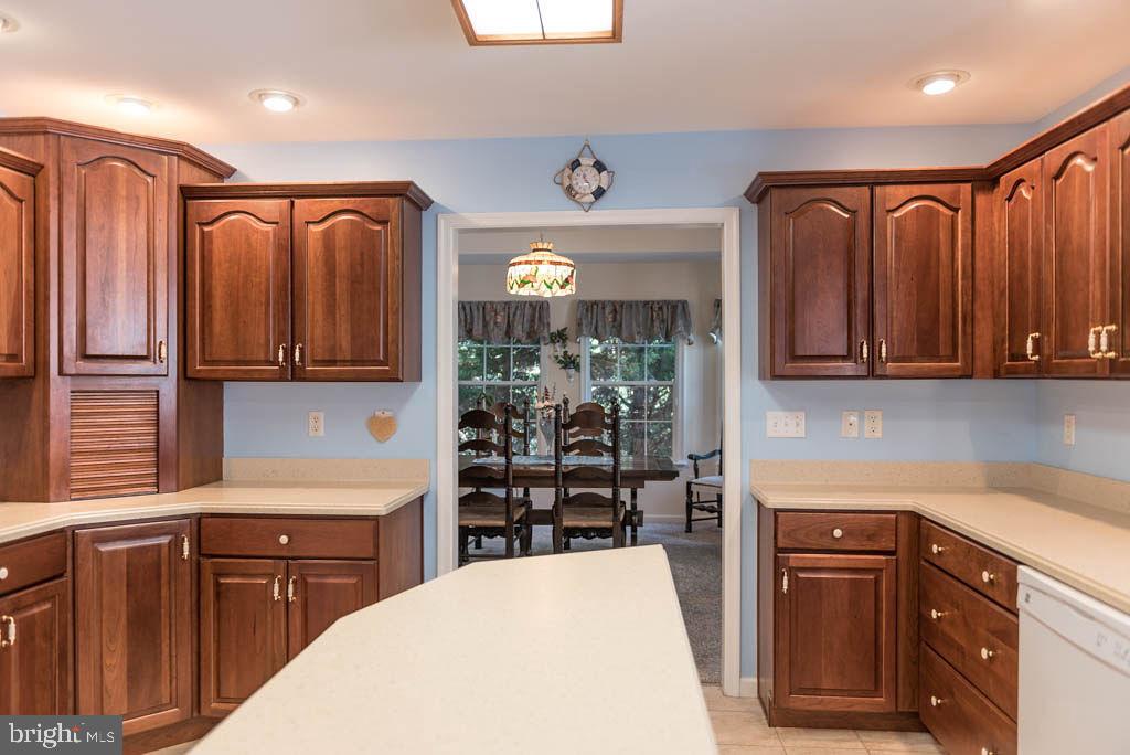 18 Brookside Road Berlin, MD 21811 - Photo 12 of 48 a kitchen with stainless steel appliances granite countertop a refrigerator a sink dishwasher and wooden cabinets with wooden floor