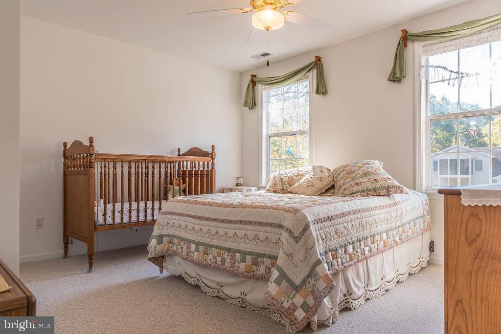 18 Brookside Road Berlin, MD 21811 - Photo 24 of 48 a bedroom with a bed and a chandelier
