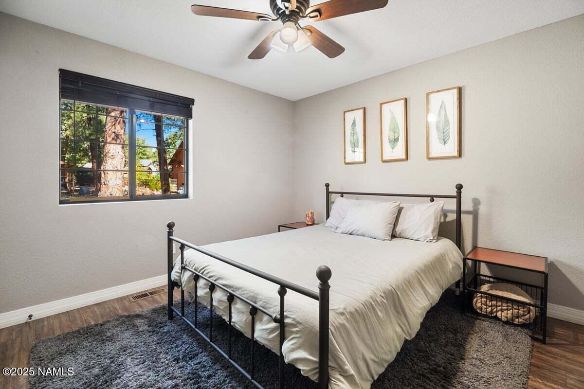 865 Caribou Road Munds Park, AZ 86017 - Photo 11 of 24 a bedroom with a bed and a window