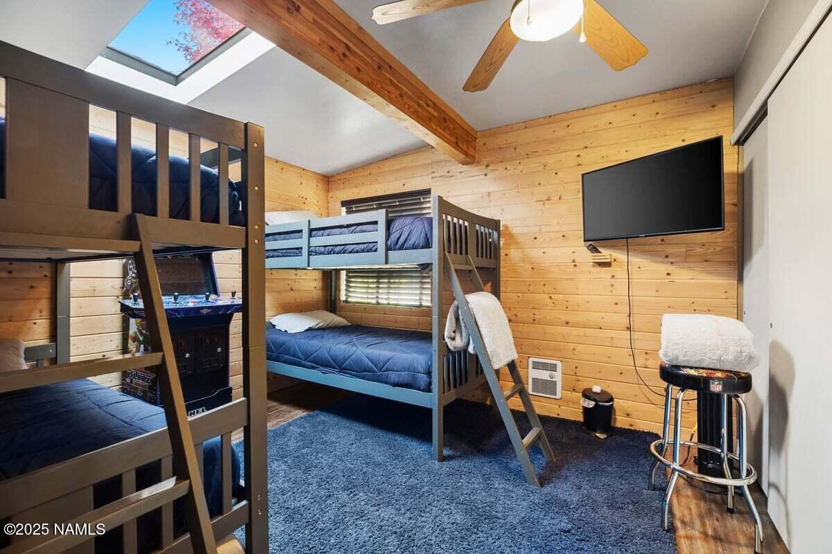 865 Caribou Road Munds Park, AZ 86017 - Photo 17 of 24 a bedroom with furniture and a flat screen tv