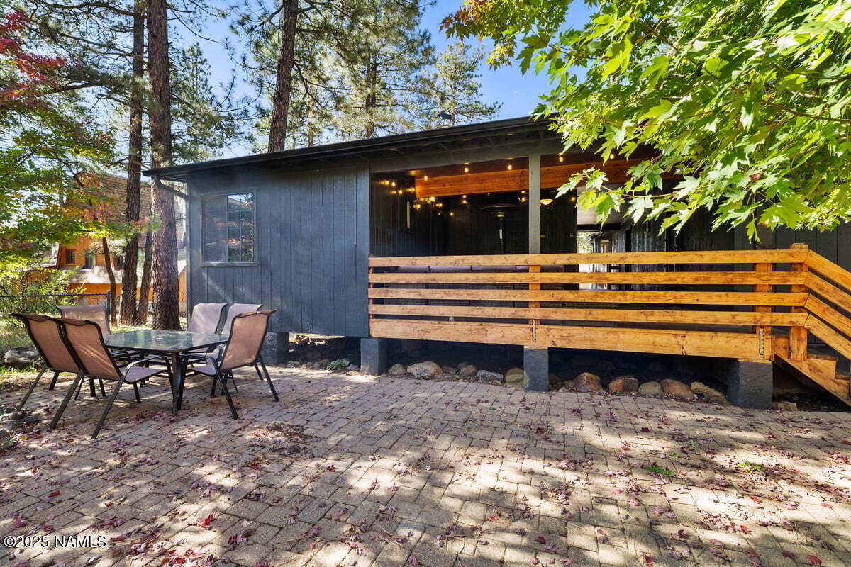 865 Caribou Road Munds Park, AZ 86017 - Photo 18 of 24 a backyard of a house with barbeque oven table and chairs